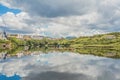 Mirror reflection in the port of Clifden at high tide and the village in the background