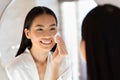 Mirror reflection of pretty asian woman using tonner Royalty Free Stock Photo