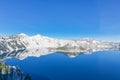 Scenic winter mirror reflection of snowcap mountain and Wizard Island on Crater Lake Royalty Free Stock Photo