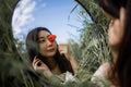 Mirror Reflection Of Young Pretty Asian Woman Holding Red Poppy Flower In Green Field Royalty Free Stock Photo