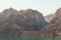 Mirror surface of Lake Iskanderkul at dawn amid the mountains Royalty Free Stock Photo