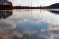 The mirror surface of the lake reflects the sky with clouds Royalty Free Stock Photo