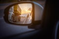 Mirror to see perspective road behind on sunset time Royalty Free Stock Photo