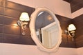 Mirror and two sconces in a bathroom