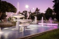 Water fountain illuminated whith colored lights at night. Royalty Free Stock Photo