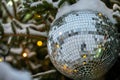 close-up of a New Year\'s toy disco ball. beautiful New Year tree with golden lights Royalty Free Stock Photo