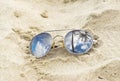 Mirrored sunglasses close up on the beach sand with palm trees reflection Royalty Free Stock Photo