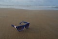 Mirrored sunglasses close up on the beach sand with palm trees reflection Royalty Free Stock Photo