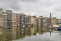 Mirroring of houses on the Damrak water surface in the centre of Amsterdam, Netherlands