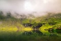 Mirroring lake on the mountain fog.Useful as background. Royalty Free Stock Photo