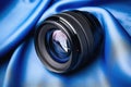 mirrorless camera lens over a clean blue cloth Royalty Free Stock Photo