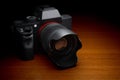 Mirrorless interchangeable-lens camera. Digital camera on wooden table, 3D rendering