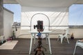 Mirrorless photo camera with tripod and trigger cable on terrace of photography studio Royalty Free Stock Photo