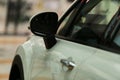 Mirrors, white car. Rear-view mirrors of a new white car with bokeh background.