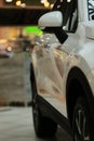 Mirrors, white car. Rear-view mirrors of a new white car with bokeh background