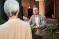 Mirthful man making order at the bar counter