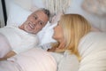 Mirthful man and woman in bed stock photo