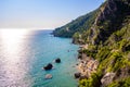 Mirtiotissa beach with crystal clear azure water and white beach in beautiful landscape scenery - paradise coastline of Corfu Royalty Free Stock Photo