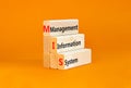 MIS management information system symbol. Concept words MIS management information system on wooden blocks on beautiful orange