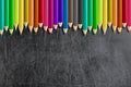 Misaligned coloured pencils blank blackboard chalkboard