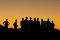 Misaligned group of people silhouettes at sunset