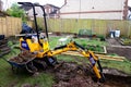 Mini digger preparing ground for foundations. Royalty Free Stock Photo