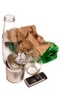 Miscellaneous household trash: glass, plastic, paper, metal, phone battery on white background. Recycling concept