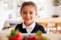 Mischievous Girl Wearing School Uniform Taking Strawberry From Kitchen Counter Royalty Free Stock Photo