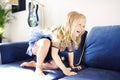 Mischievous preschooler girl jumping on a sofa.