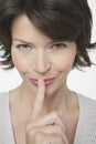 Mischievous Woman Gesturing Silence Royalty Free Stock Photo