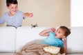 Gotcha. Mischievous young boy scaring his little sister at Halloween with a rubber spider. Royalty Free Stock Photo