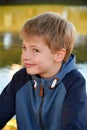 Mischievously laughing schoolboy with blond hair Royalty Free Stock Photo