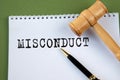 MISCONDUCT - word on a white sheet with a judge\'s gavel Royalty Free Stock Photo
