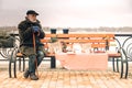 Miserable cold poor man sitting on bench in park Royalty Free Stock Photo