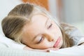 Miserable female child posing in couch at home