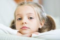 Miserable female child posing in couch at home