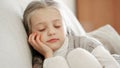 Miserable female child posing in couch at home