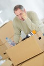 Miserable man with belongings in cardboard boxes Royalty Free Stock Photo