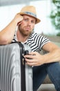 miserable man sat with suitcase Royalty Free Stock Photo