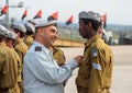 Officers of the IDF reward the soldier with the insignia at the formation in Engineering Corps Fallen Memorial Monument in Mishmar