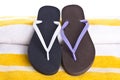 Mismatched Flip Flop on Yellow Striped Beach Towel Royalty Free Stock Photo