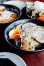 Miso Chashu Ramen: Japanese noodle in Miso soup with chashu pork, boiled egg, dry seaweed and chives in black bowl. Royalty Free Stock Photo