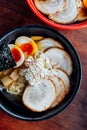 Miso Chashu Ramen: Japanese noodle in Miso soup with chashu pork, boiled egg, dry seaweed and chives in black bowl. Royalty Free Stock Photo