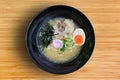 Miso Ramen Asian noodles with chashu Pork, seaweed and boiled egg in black bowl on bamboo wooden background, top view Royalty Free Stock Photo