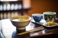 miso soup in asian restaurant setting, dim lighting, tableware Royalty Free Stock Photo