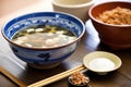 miso soup in ceramic bowl, wooden spoon, soybeans in background Royalty Free Stock Photo