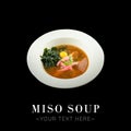 Miso soup with tuna, buckwheat noodles, quail egg, seaweed isolated on black background ready food banner with text space Royalty Free Stock Photo