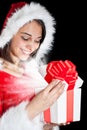 Miss Santa opening a gift box Royalty Free Stock Photo