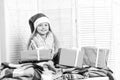 Miss Santa in red hat covered with blanket holds presents Royalty Free Stock Photo