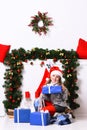 Miss Santa in red hat holds blue gift boxes Royalty Free Stock Photo